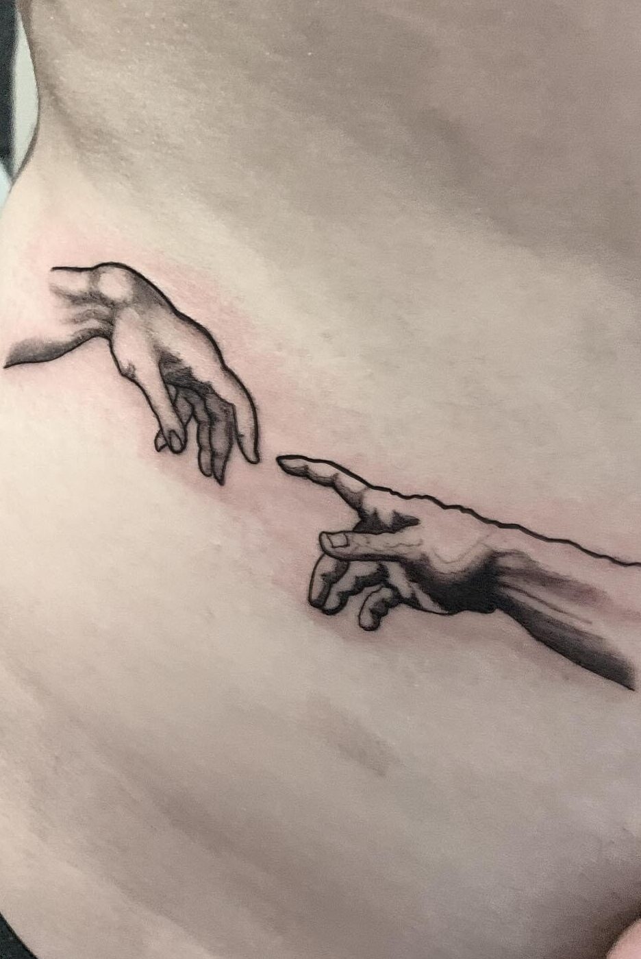 Renaissance artist Michelangelo ‘The Creation of Adam’ tattoo on the hip by tattoo artist Marcus Kingsland at Markings Tattoos in Beverley, East Riding of Yorkshire.