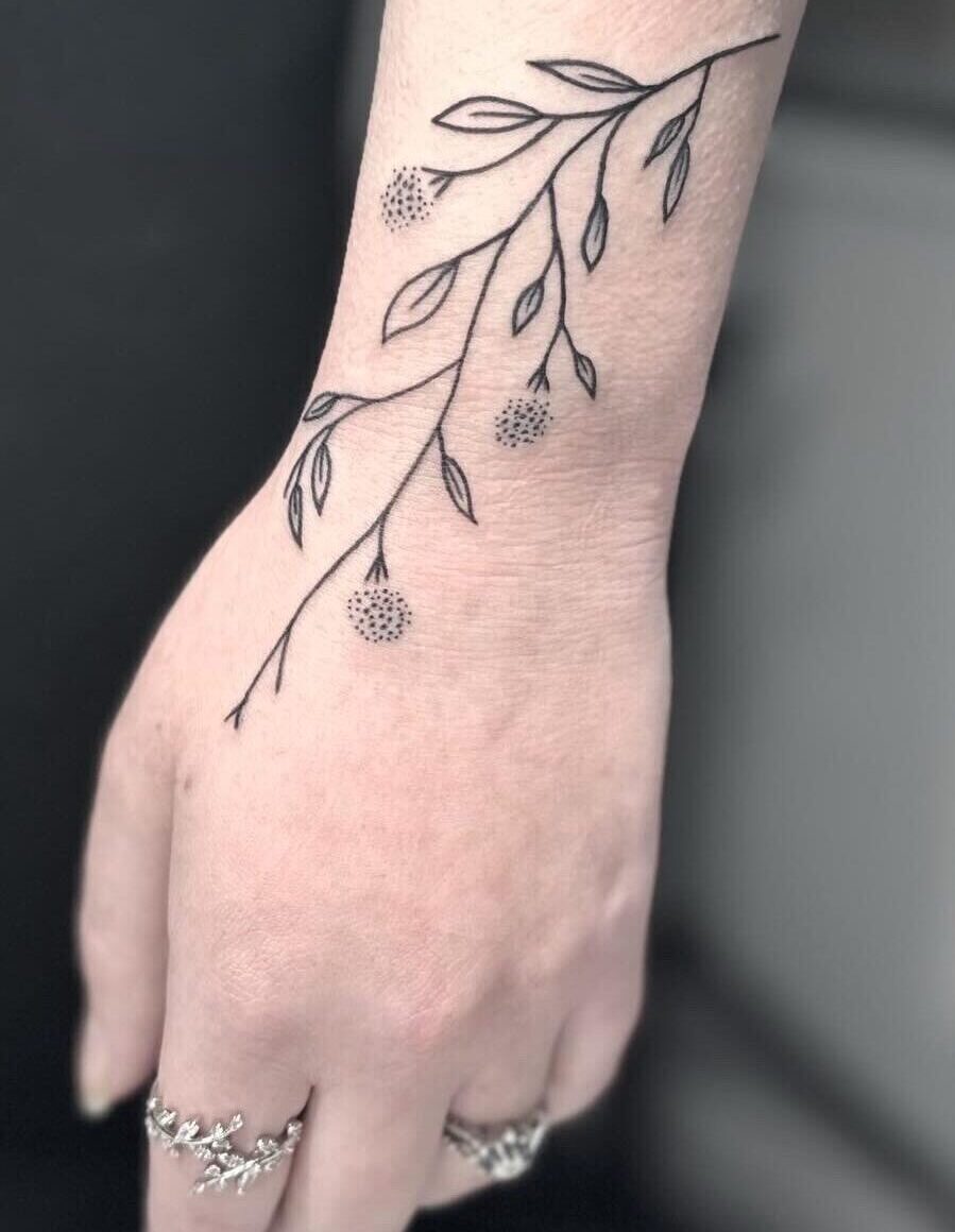 Fine line floral leaf tattoo by tattoo artist Marcus Kingsland at Markings Tattoos in Beverley, East Riding of Yorkshire.