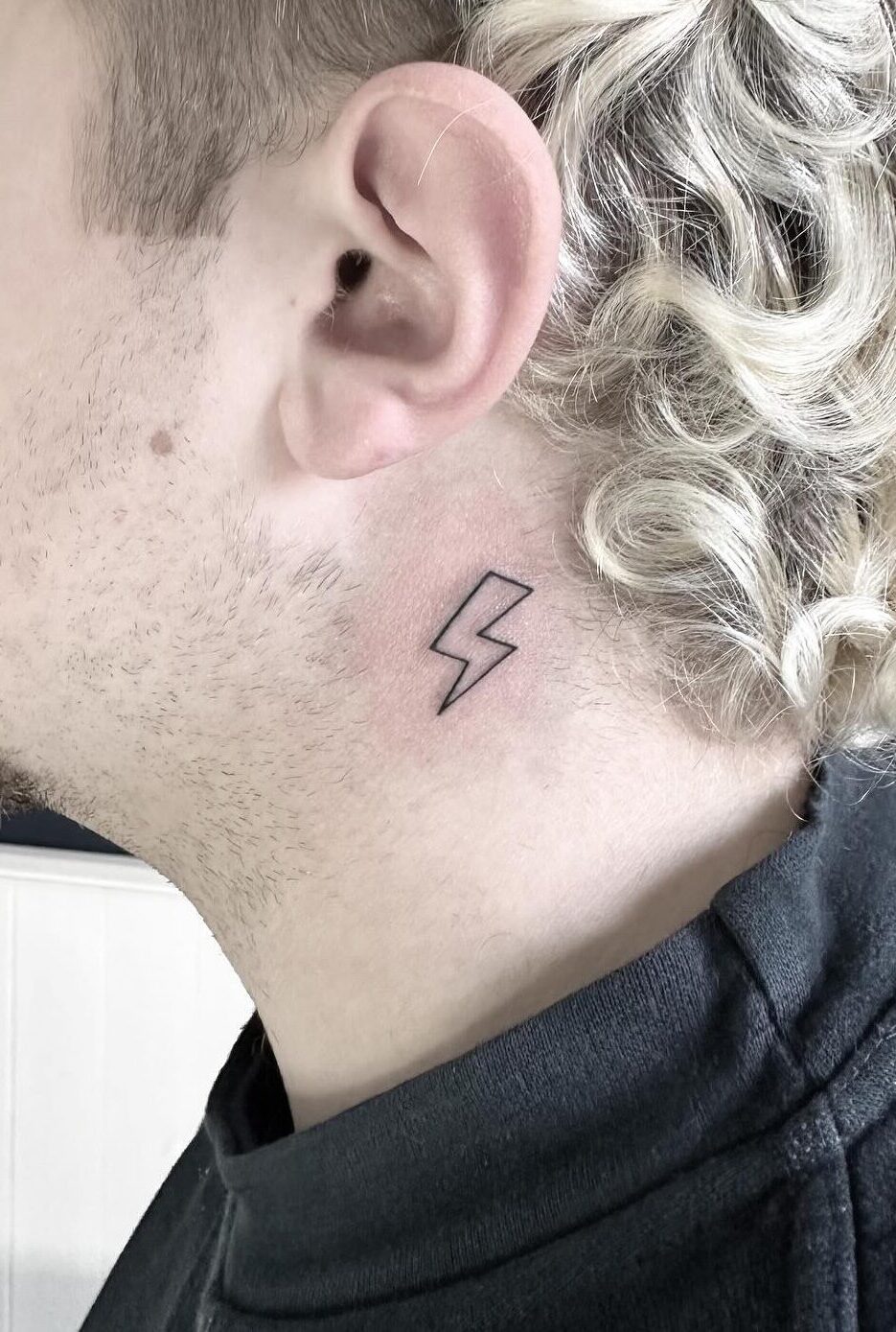 Fine line thunderbolt tattoo by tattoo artist Marcus Kingsland at Markings Tattoos in Beverley, East Riding of Yorkshire.