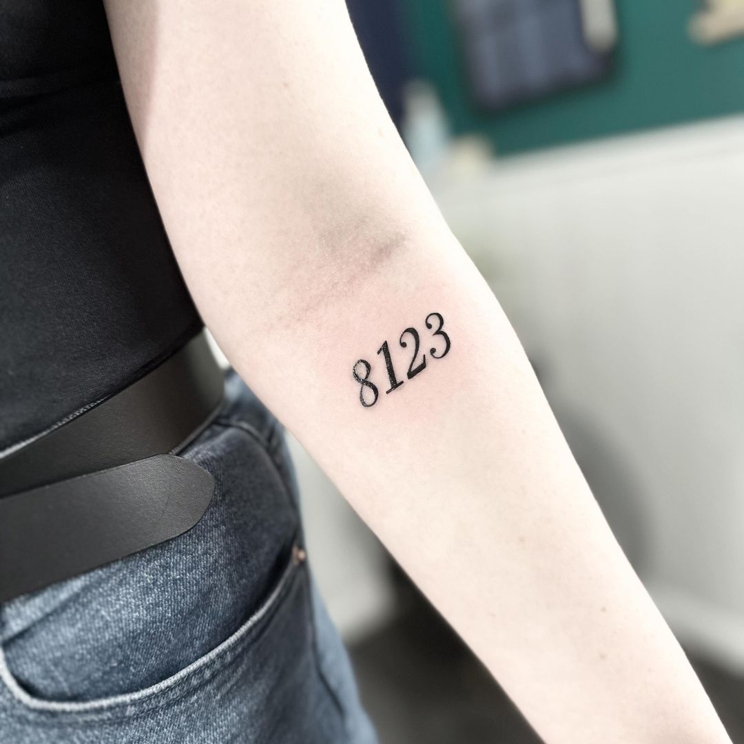 Italic numbers tattoo by artist Marcus Kingsland at Markings Tattoos in Beverley, East Riding of Yorkshire.