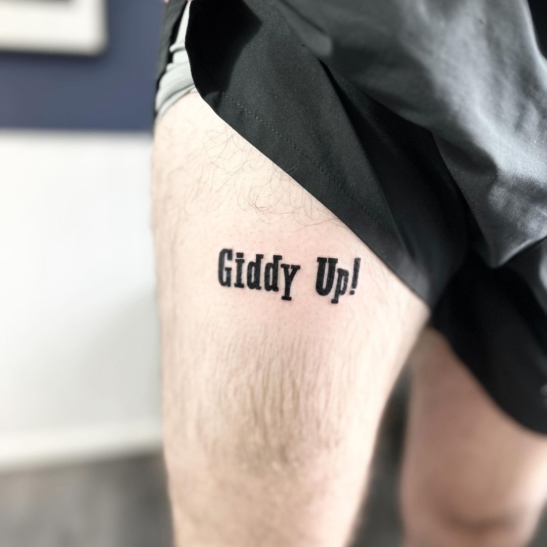 Giddy Up script tattoo by artist Marcus Kingsland at Markings Tattoos in Beverley, East Riding of Yorkshire.