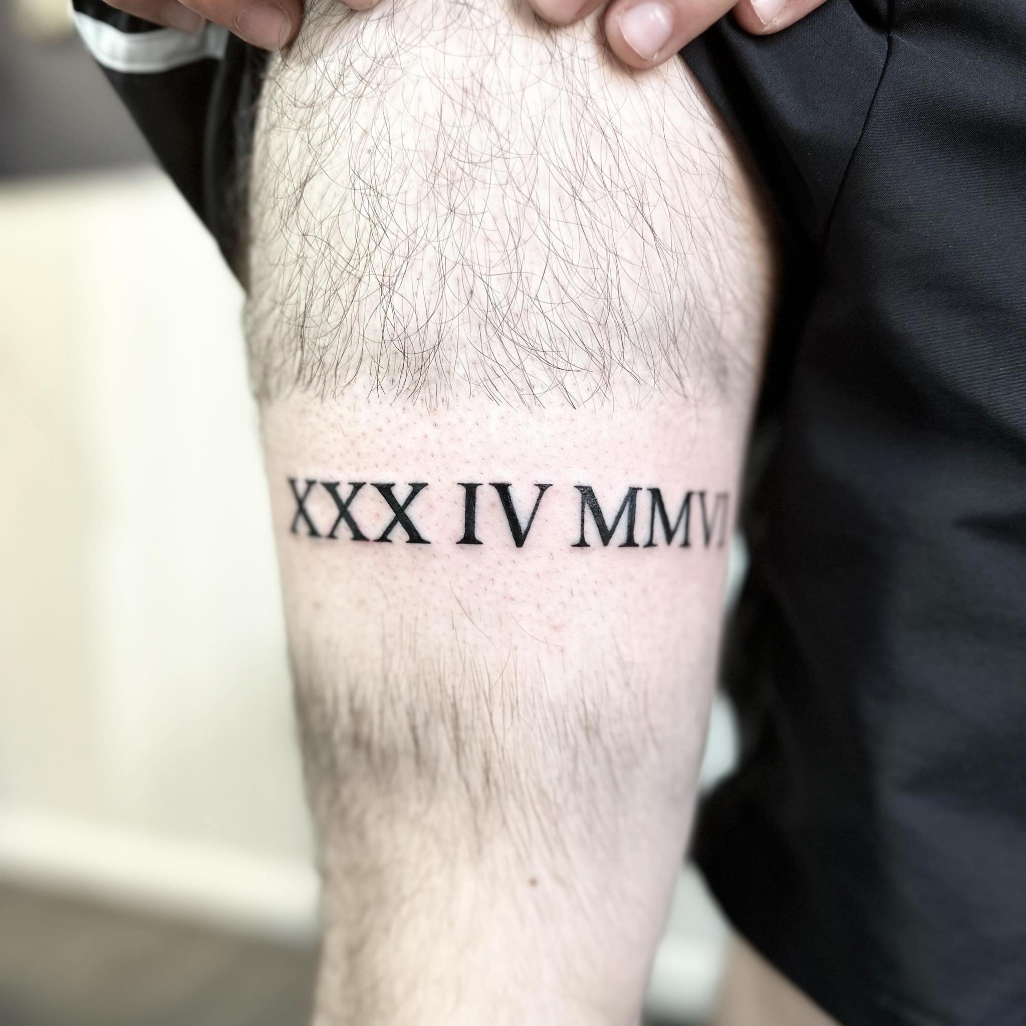 Times New Roman numerals tattoo by artist Marcus Kingsland at Markings Tattoos in Beverley, East Riding of Yorkshire.