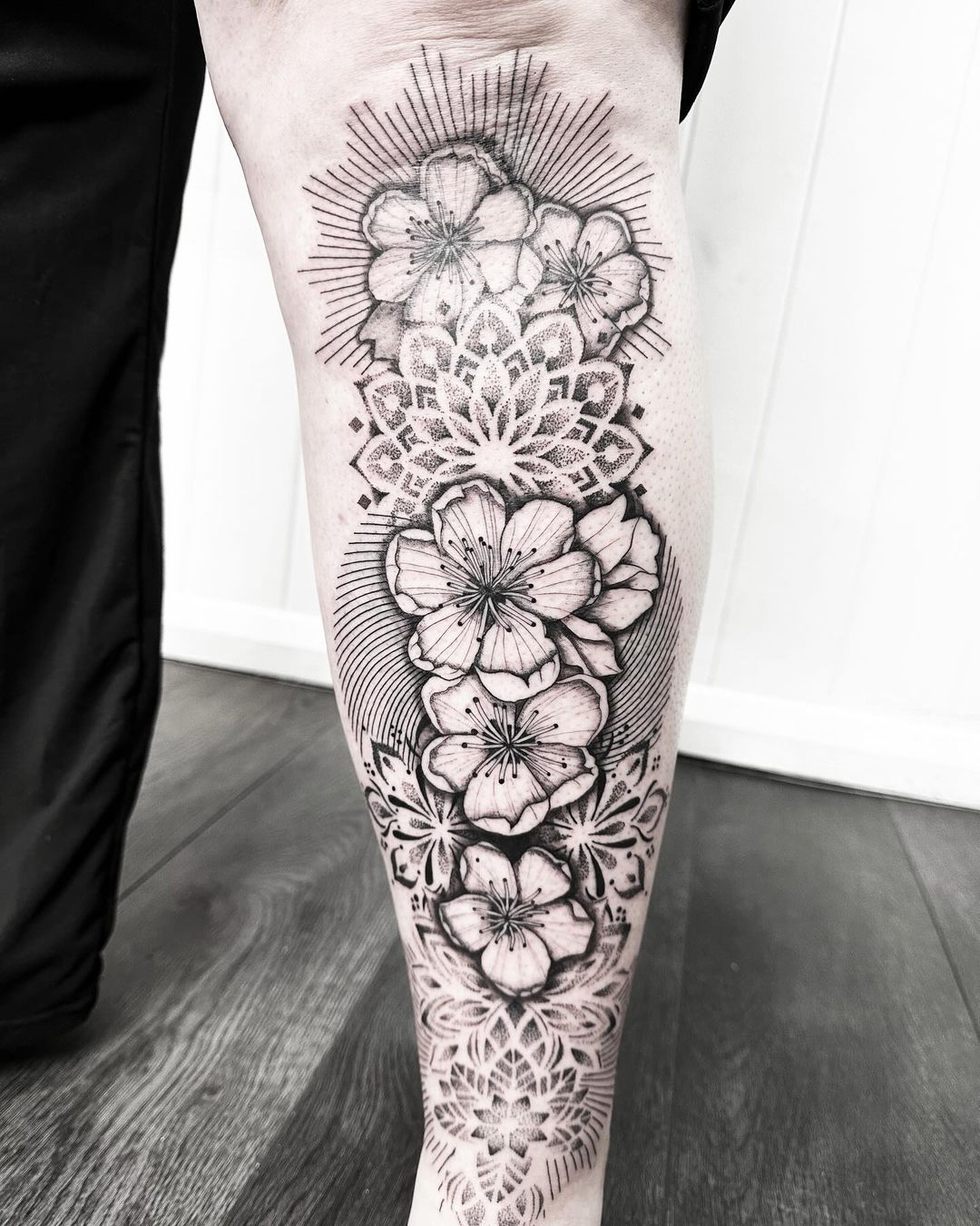 Flowers and mandala leg tattoo by artist Marcus Kingsland at Markings Tattoos in Beverley, East Riding of Yorkshire.